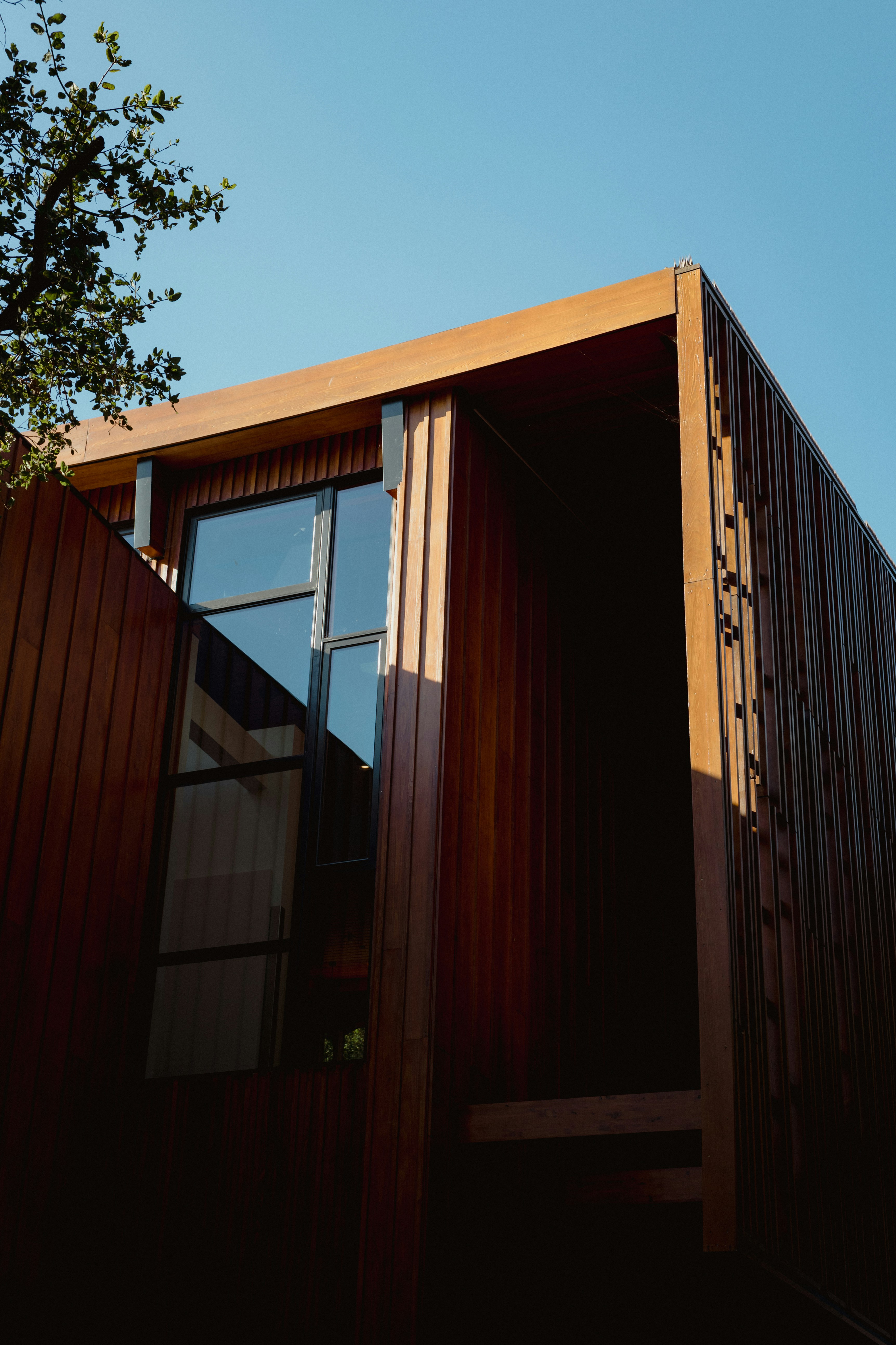 Contemporary timber home under clear blue sky